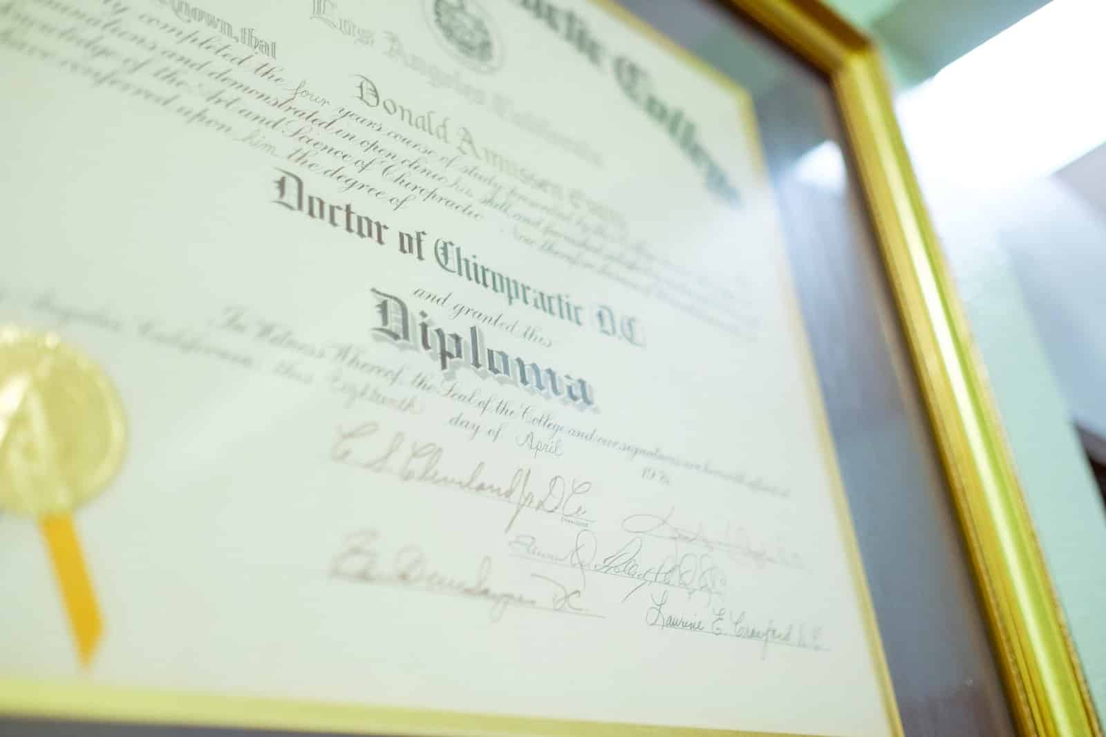 a framed diploma with a gold seal on it
